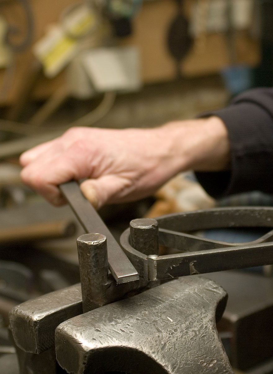 Bending the iron bars of the chandelier frame